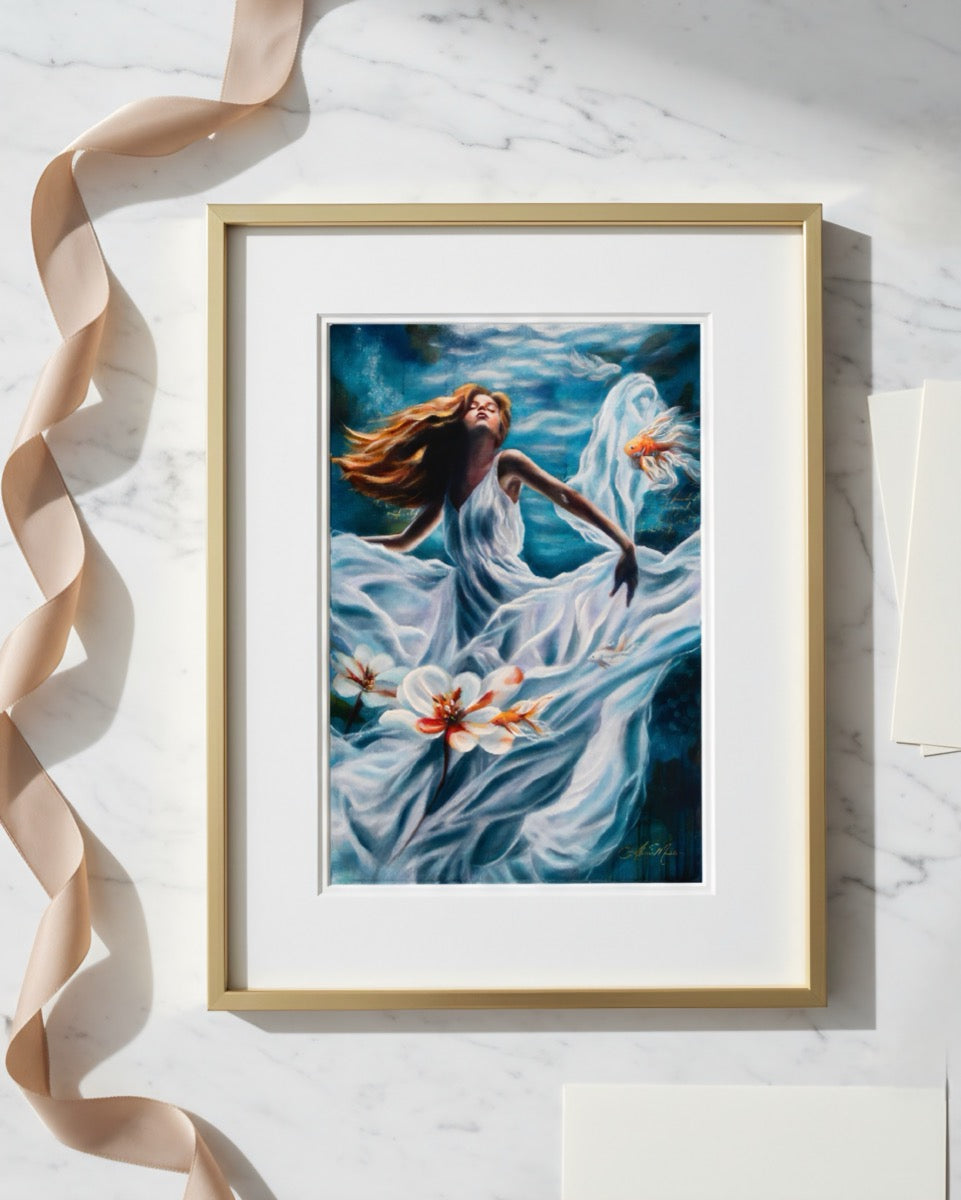 Framed artwork of a woman in a white dress with flowers on a marble surface